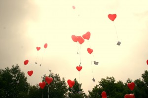 Heart balloons with messages floating into the sky